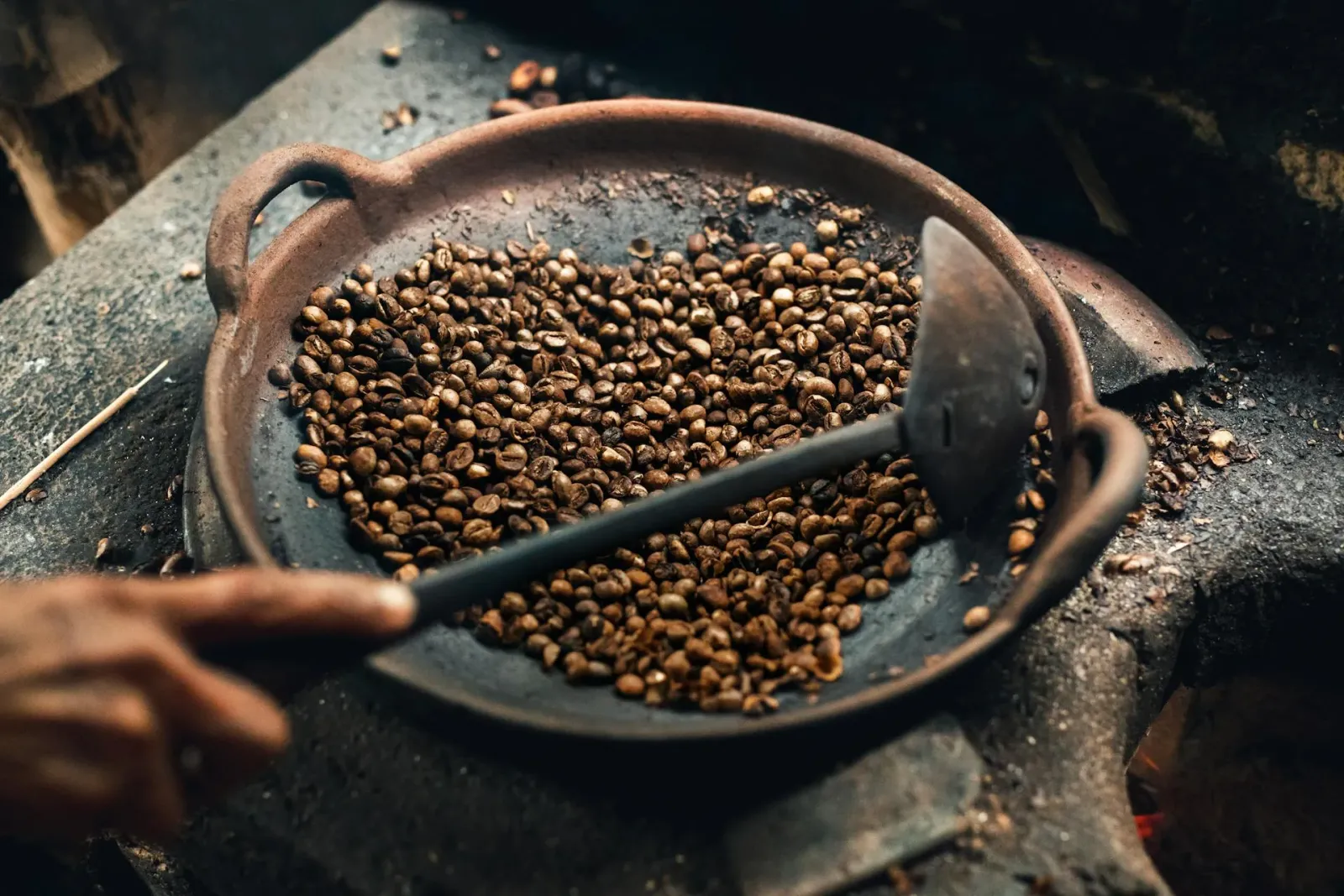 Dark roasted coffee beans in low light
