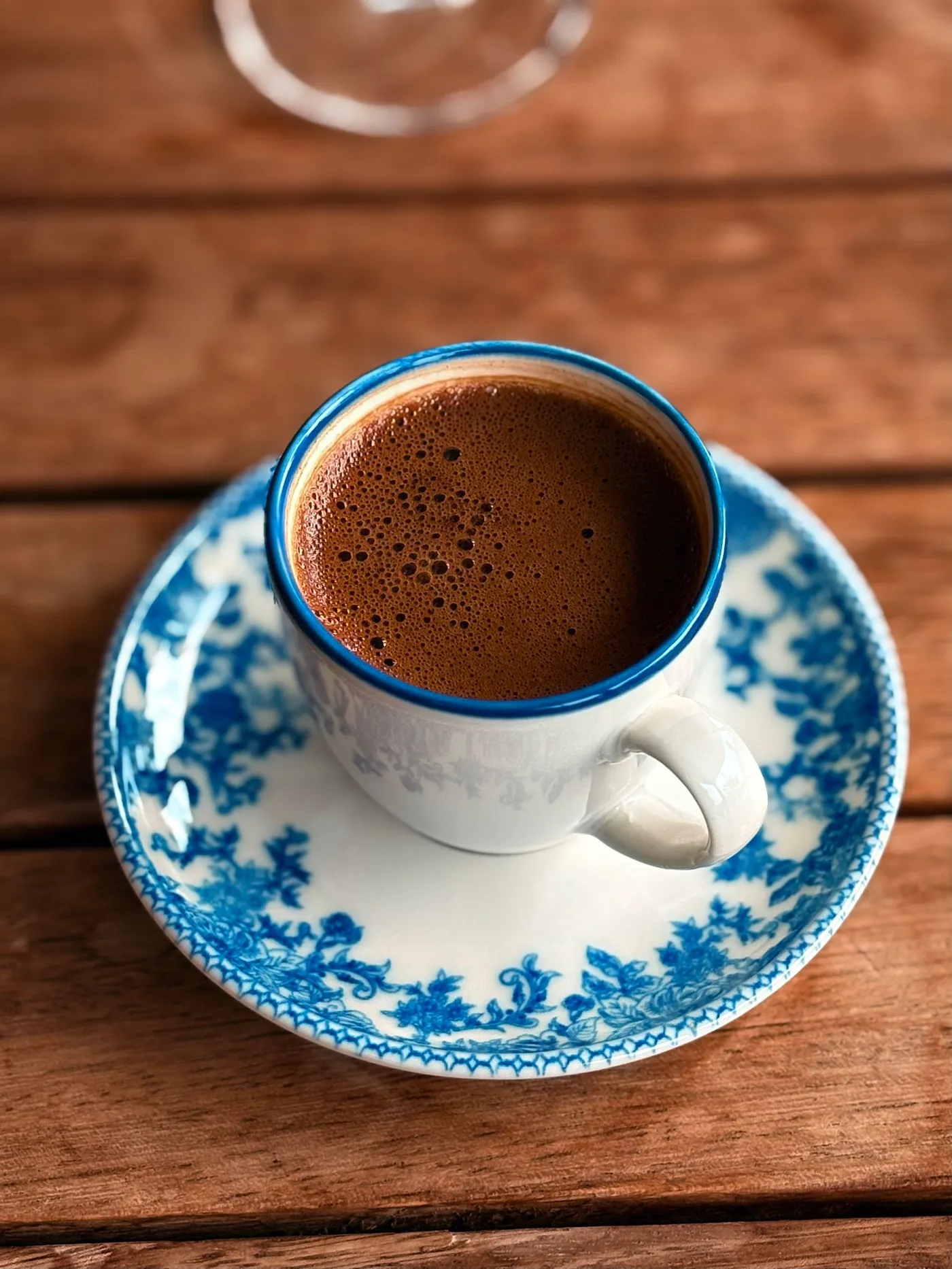 Turkish coffee in a blue-patterned cup with a piece of lokum