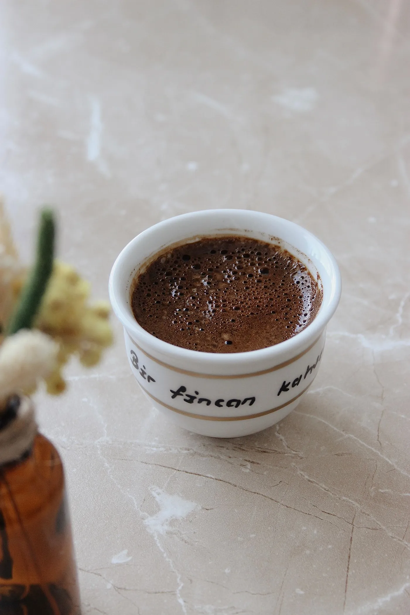 A cup of Turkish coffee on a marble table