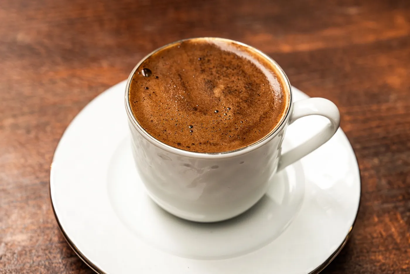 A close-up of the foam on a cup of Turkish coffee