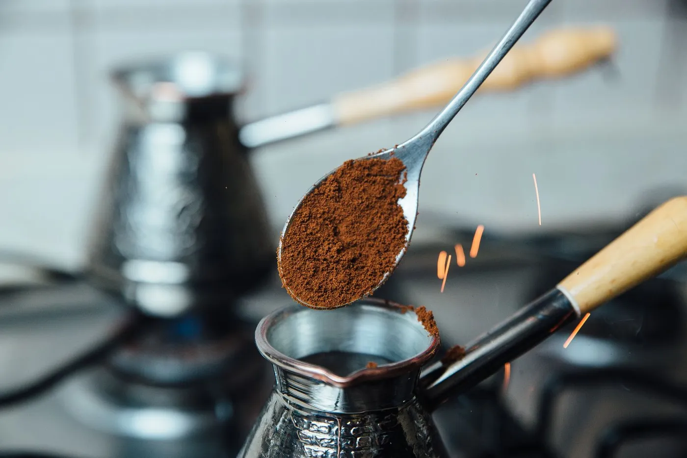 Powder-fine Turkish coffee being spooned into a cezve